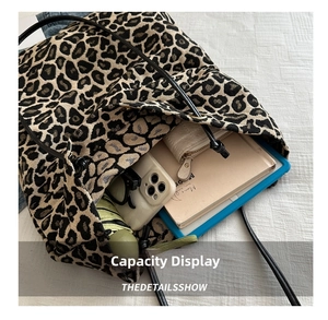 Interior view of leopard print tote bag showing large capacity for iPad, phone, and umbrella