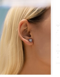 Macro shot of S925 silver heart stud earrings with blue diamonds and white zircon gems