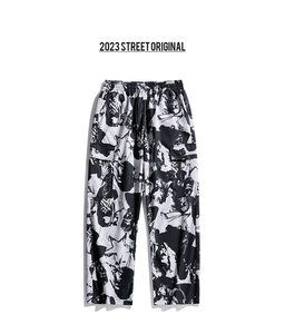 Close-up of cargo trousers with black and white abstract print and side pockets