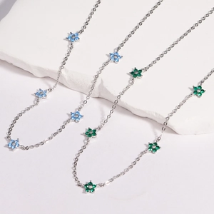 Macro detail of floral necklaces with colorful blue and green crystal inlaid petals
