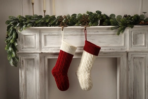 Close-up of cable knit Christmas stockings in red and white on a festive mantel