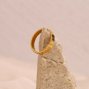 18K gold plated stainless steel ring with unique fish scale texture on a beige stone