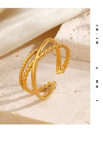Detail of gold layered open ring featuring textured beads and smooth polished surface