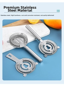 Close-up of three polished stainless steel Hawthorne cocktail strainers on a marble board