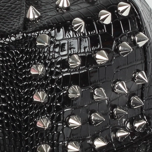 Macro detail of black crocodile texture leather with silver punk metal spikes on a hip-hop hat