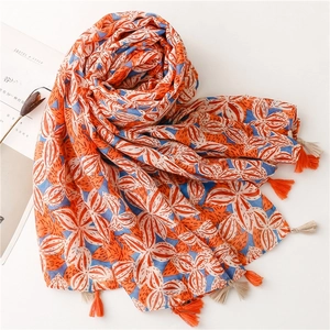 Gardenia print cotton linen scarf in blue and orange with fringe, flat lay style