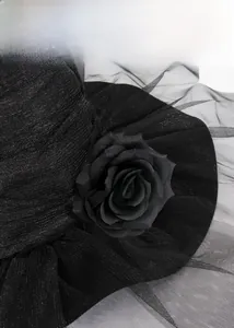 Detailed close-up of gothic witch hat featuring delicate mesh and silk rose embellishments
