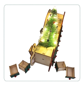Detail of wooden Christmas advent calendar sled with small drawers and lighted LED tree