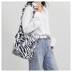 Close-up of zebra print faux fur tote bag with soft texture and wide shoulder strap