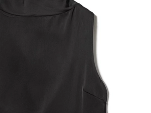 Close-up of black sleeveless satin top neck and armhole cut with smooth silky texture