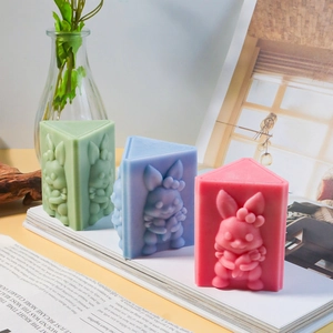 Handmade 3D rabbit relief candles in green, blue, and pink triangular prism shapes