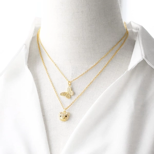 Double-layered gold necklace with sparkling zircon butterfly and bear pendants