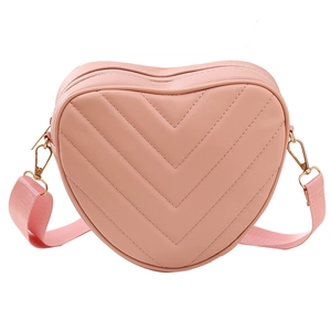 Pink heart-shaped crossbody bag with V-quilted pattern and adjustable strap for women