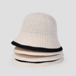 Detail showing vertical rib texture of four stacked breathable beige knit bucket hats