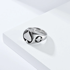 Macro detail of men's stainless steel signet ring with black Ace of Spades poker motif