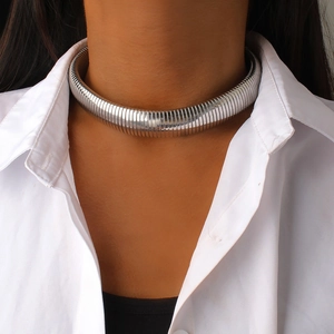 Close-up of polished silver titanium choker necklace featuring a dense ribbed texture