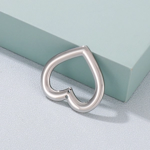 Polished silver hollow heart stainless steel pendant on a minimalist geometric background