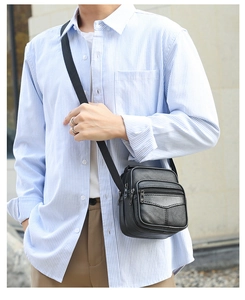 Side view of men's black lychee leather crossbody bag with multiple zippers