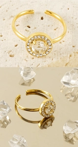 Macro detail of gold-plated stainless steel ring with halo-set round zircon and crystals