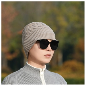 Close-up of beige ribbed knit beanie texture with thick thermal fabric for winter