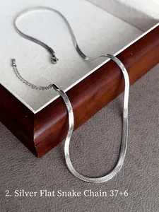 Silver snake chain necklace 37+6cm with lobster clasp on a dark wooden tray