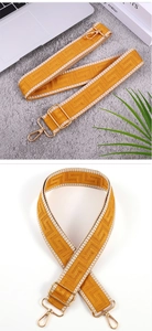 Close-up of mustard yellow wide strap with geometric weave and gold metal hooks