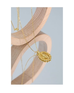 Macro shot of gold tulip embossed oval pendant on a delicate S925 sterling silver chain