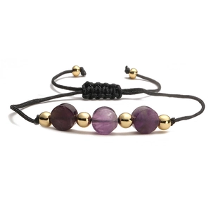 Adjustable black woven bracelet with purple natural stones and polished gold metal beads