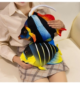 Set of two colorful plush tropical fish pillows on a sofa, vibrant home decor plushies