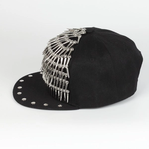 Close-up of black hip hop snapback cap with silver metal spikes and round studs detail