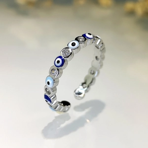 Macro shot of silver evil eye ring with blue enamel and sparkling cubic zirconia stones