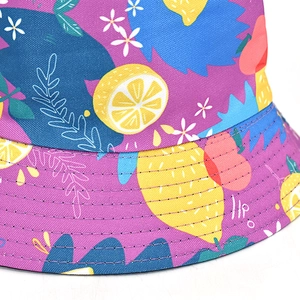Close-up of vibrant lemon and floral print detail on durable purple sun bucket hat fabric