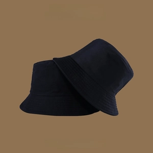 Detail of black double-sided bucket hat with UV protection and reinforced stitching