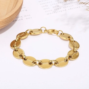 Detail of a gold stainless steel coffee bean link bracelet with lobster clasp and mirror finish