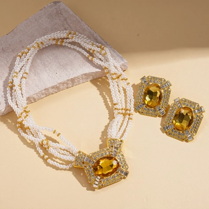 Elegant vintage multi-layer pearl necklace and amber gemstone earrings set in gold