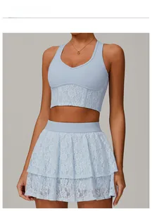 Detail of water ripple blue sports top featuring intricate rose lace stitching and V-neck