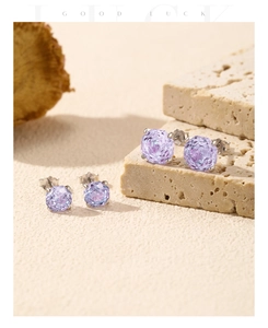 Detailed view of s925 silver stud earrings with purple rose cut faux amethysts