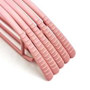 Pink plastic clothes hangers with non-slip wide shoulder design and textured grip surface
