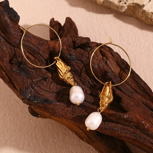 Detail of 18K gold plated hoop earrings with shell charms and teardrop pearls