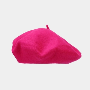 Detailed texture of high-quality wool beret hat in vibrant rose red solid color