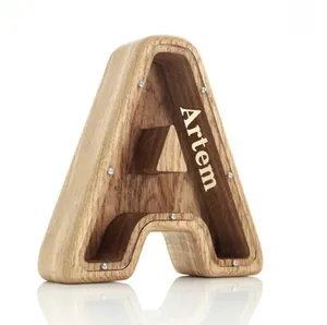 Macro view of alphabet A oak wood money box with transparent panel and custom name