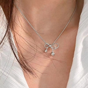 Elegant bow pendant necklace with silver beads on a delicate snake chain for women
