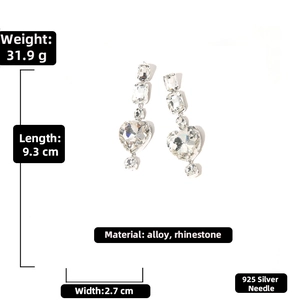 Macro view of long rhinestone heart drop earrings with 925 silver needle size specs