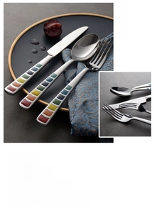 Detail of colorful resin handle on stainless steel cutlery set with modern pattern