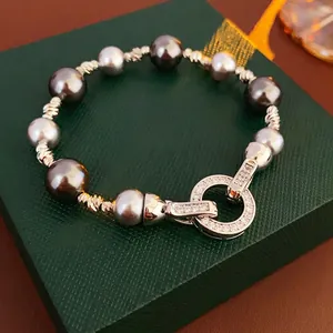 Mixed color pearl bracelet with twisted metal spacers and zircon pavé clasp on jewelry box