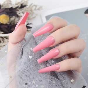 Detail shot of long coffin pink press-on nails with a high-gloss UV finish and smooth surface