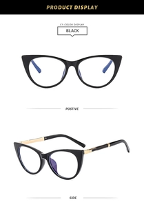 Detail of black cat-eye frames with golden metal accents and decorative crystals