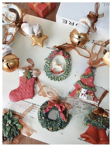 Detailed close-up of retro resin Christmas ornaments with ribbons on vintage background