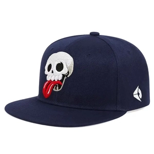 Dark blue flat brim baseball cap with white skull and red tongue embroidery details