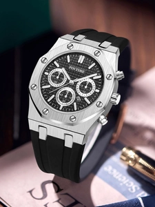 Detailed view of silver octagonal chronograph watch with black rubber strap and textured dial